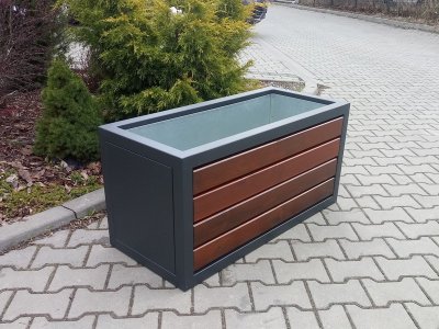 Parkbänk med blomkruka och sopkorg